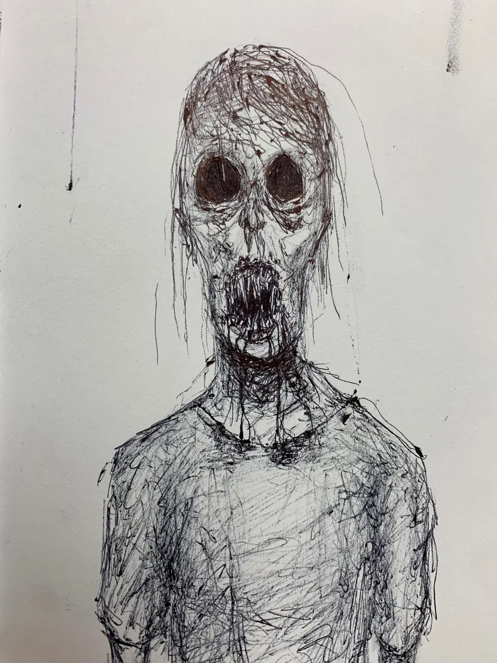 A scrawled figure with hollow eyes