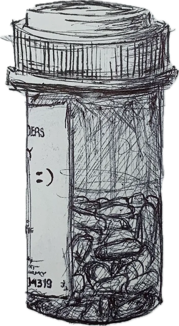 A pill bottle filled with strange contents